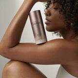 Woman holding a 'plated' product container against a neutral background